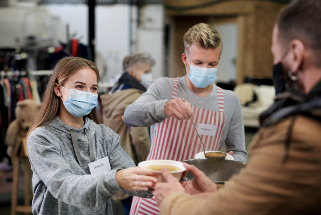 Volunteers,Serving,Hot,Soup,For,Homeless,In,Community,Charity,Donation